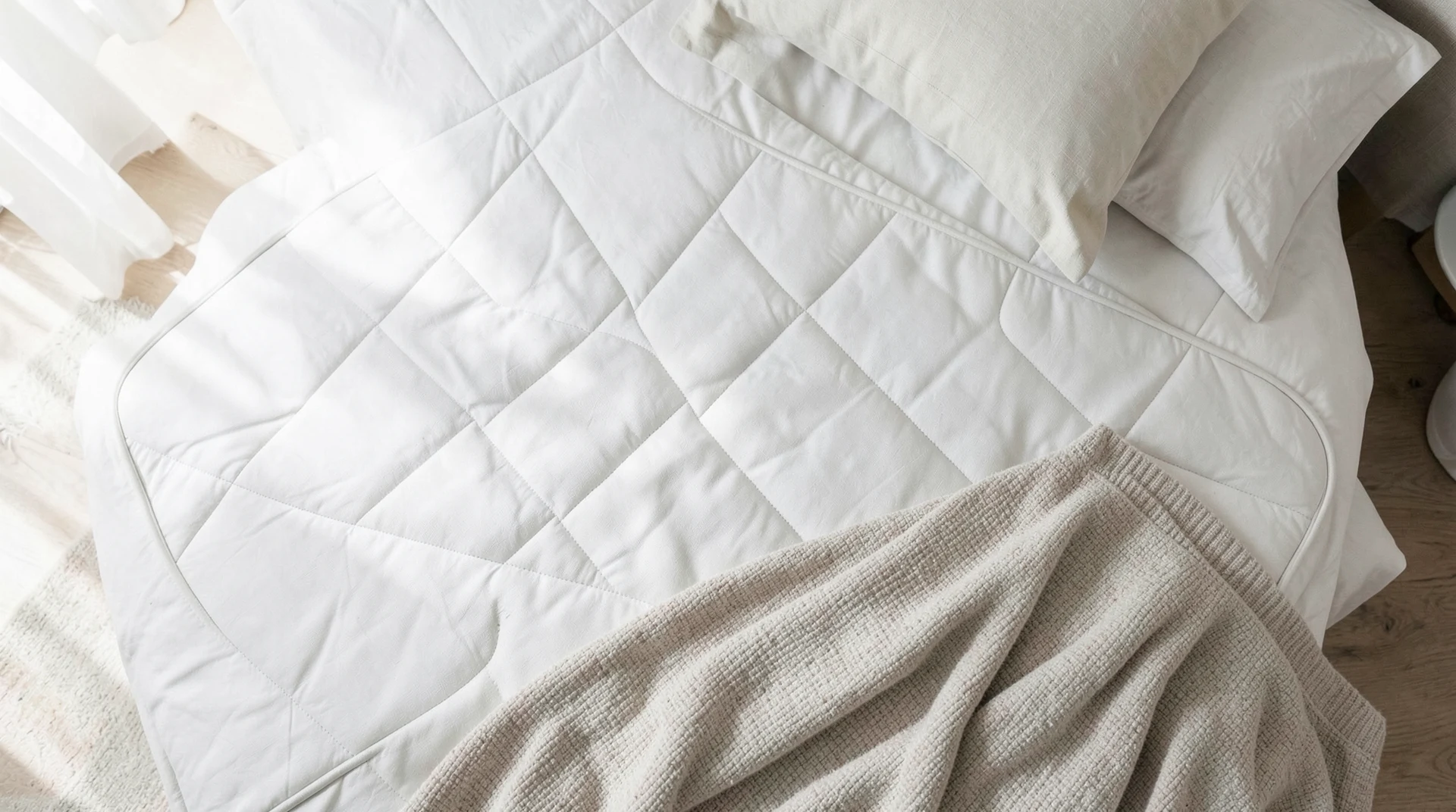 Mattress topper and pillow on bed